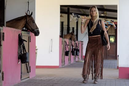 “Amo la moda argentina, me compro especialmente ropa y accesorios de cuero”, cuenta Hope, mientras llega a las caballerizas con su última adquisición: una cartera de Las Cabrera.