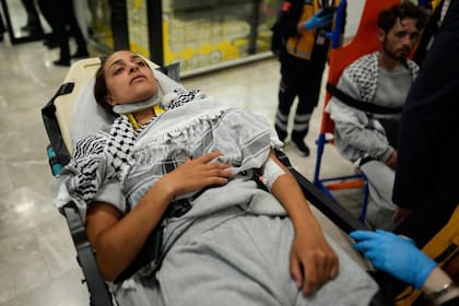 An activist from the Global Sumud Flotilla is carried on a wheel stretcher upon her arrival at Istanbul Airport, in Istanbul, Turkey, Thursday, May 21, 2026. (AP Photo/Emrah Gurel)