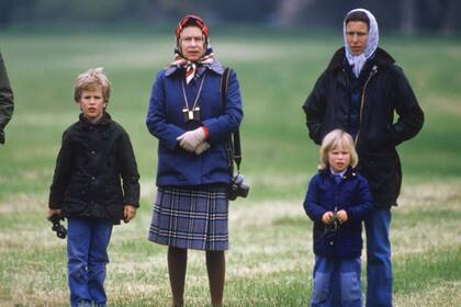 Ana en el Windsor Horse Show, en 1985, con sus hijos Peter y Zara y su madre, la reina Isabel. De ella, la princesa heredó su pasión por los caballos, los perros, la vida al aire libre y ciertos tips a la hora de vestirse, como los colores y los pañuleos en la cabeza