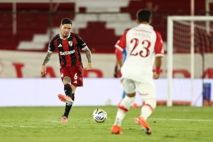 Aníbal Moreno pasa la pelota, ante la mirada de Thaiel Peralta