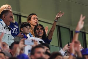 Argentina's forward Lionel Messi's wife, Antonela Roccuzzo (R) wave from the stands next to her son Ciro, during the Qatar 2022 World Cup round of 16 football match between Argentina and Australia at the Ahmad Bin Ali Stadium in Al-Rayyan, west of Doha on December 3, 2022. (Photo by FRANCK FIFE / AFP)