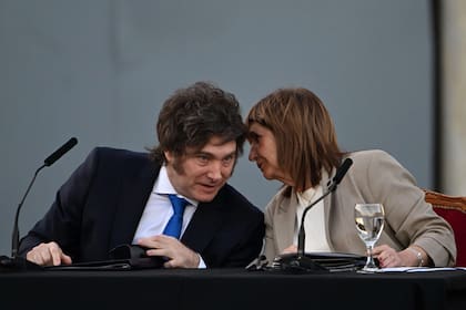 Argentina's President Javier Milei (L) listens to Security Minister Patricia Bullrich during the official presentation of a comprehensive reform bill for the Penal Code at Federal Penitentiary Complex No. 1 in Ezeiza, Buenos Aires province, on October 2, 2025. (Photo by Luis ROBAYO / AFP)