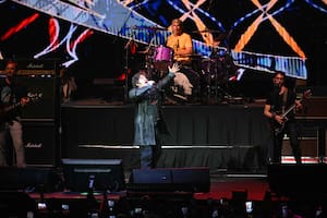 Argentina's President Javier Milei sings during his launch book La construcción del milagro at Movistar Arena in Buenos Aires on October 6, 2025 (Photo by Luis Robayo/AFP)