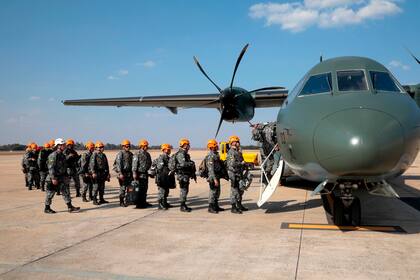 Bomberos del Ejército Nacional de Brasil se preparan para subir a un avión que los llevará a la zona de incendios