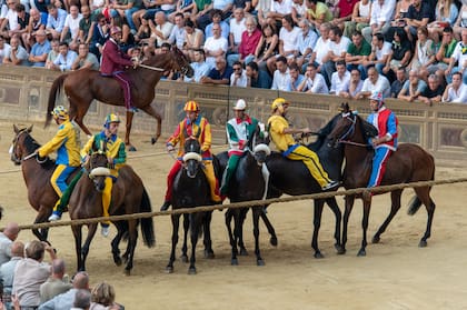 Aún hoy gana el caballo que haya cumplido tres vueltas a la plaza, con o sin jinete, mientras mantenga puesta durante la corrida la escarapela del barrio. Gentileza del Consorzio per la Tutela del Palio di Siena.