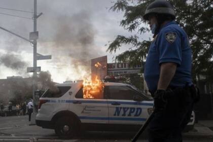 Autos de policía en Nueva York fueron atacados tras la muerte de George Floyd.
