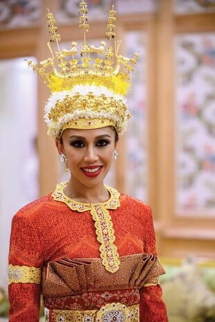 Azemah –a quien se la conoce como la princesa deportista– en el palacio real, vestida según el ritual asiático: con un tradicional atuendo en rojo y dorado para la colorida “ceremonia del polvo”, antes de recibir las bendiciones de familiares y amigos.