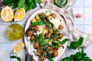 baked baby potatoes with burrata and pesto.selective focus