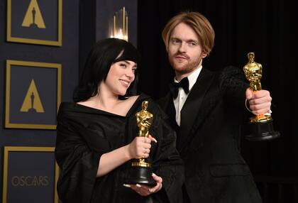 Billie Eilish, left, and Finneas, winner of the award for best original song for "No Tie To Die" from "No Time To Die", pose in the press room at the Oscars on Sunday, March 27, 2022, at the Dolby Theatre in Los Angeles. (Photo by Jordan Strauss/Invision/AP)