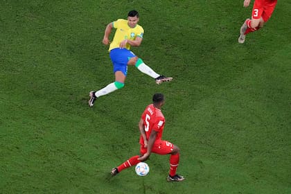 Brazil's Casemiro, top, scores his side's opening goal during the World Cup group G soccer match between Brazil and Switzerland, at the Stadium 974 in Doha, Qatar, Monday, Nov. 28, 2022. (AP Photo/Thanassis Stavrakis)