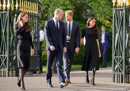 Britain's Prince William, second left, and Kate, Princess of Wales, left, and Britain's Prince Harry, second right, and Meghan, Duchess of Sussex leave the gate to view the floral tributes for the late Queen Elizabeth II outside Windsor Castle, in Windsor, England, Saturday, Sept. 10, 2022. (AP Photo/Martin Meissner)