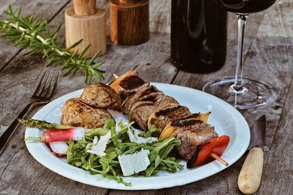 Brochette de lomo con rúcula, espárragos y lascas de queso. El menú incluye productos frescos de temporada que se cultivan en la región.