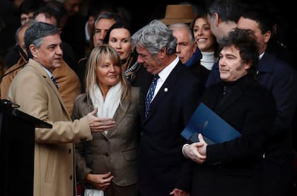 Buenos Aires City Mayor Jorge Macri (L) greets Argentina's President Javier Milei (R) during the Argentine Rural Society's expo in Buenos Aires on July 26, 2025. (Photo by AFP)