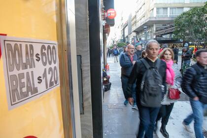 Calle Florida, negocios a la calle con carteles de la cotización del dólar blue.