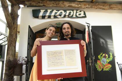 Camila Echeverria e Ian Edgar, junto a la carta que inspiró el restaurante 
