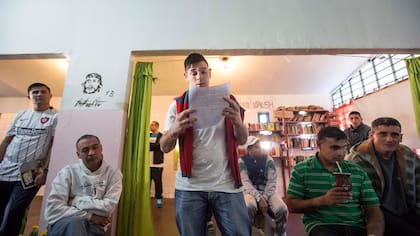 Un joven lee para sus compañeros