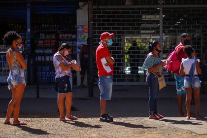 Barbijos y distancia social en la parada de ómnibus, como aconsejan los expertos, aunque el transporte público es en parte responsable de los nuevos contagios