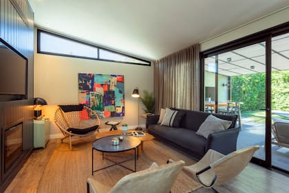 Cortinas de lino (Reina Ana Textiles), sillas (La Fábrica del Diseño), lámpara vintage, mesa ratona de roble (Dearcos) y de chapa (Samic), alfombra (Zurtan).