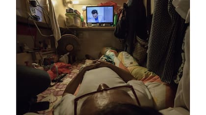 Simon Wong, una hombre desempleado mirando Tv