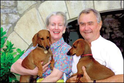 De vacaciones en el Château de Caix, en agosto de 2001, Margarita y su marido posan con dos de sus perros, Celimene y Evita.
