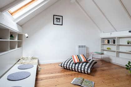 Desmontaron un viejo radiador e instalaron una placa nueva para calefaccionar. Almohadones (Luna OKS). Lámpara direccional sujetada al estante (Huup).