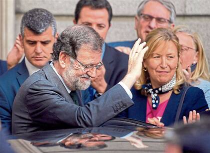 Destituido, Rajoy saluda a sus simpatizantes al retirarse ayer del Congreso