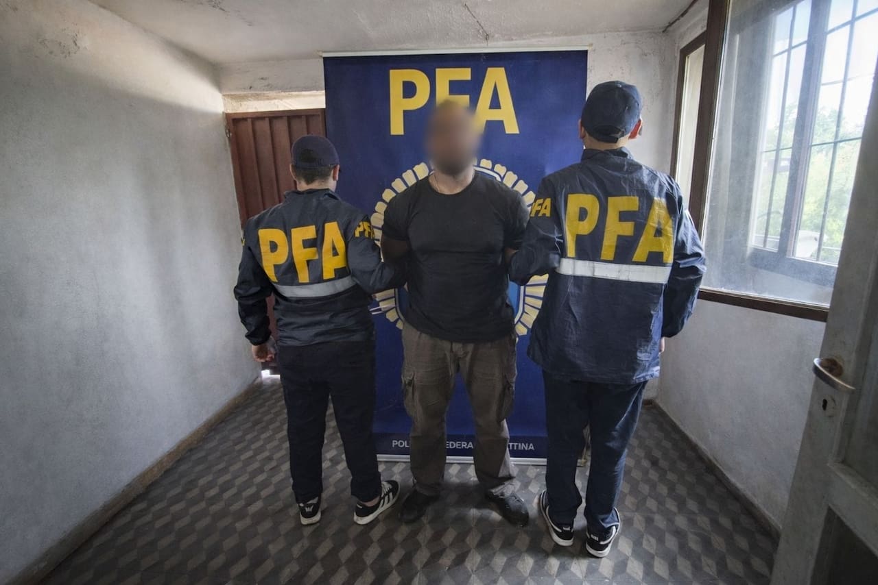 Efectivos durante un allanamiento en Mendoza; armas incautadas y personal policial