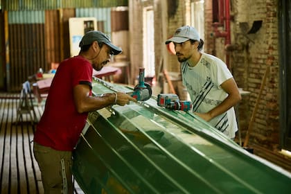 Dos socios reparan su bote, manteniendo vivo un oficio que desapareció con el último botero del club