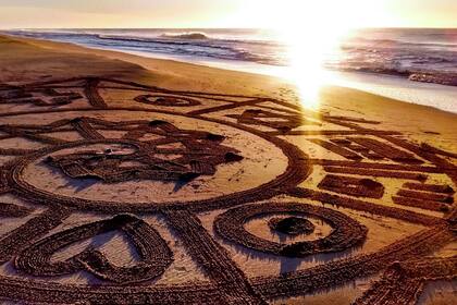 Durante la pandemia, María Lazarte, que hace 18 años vive en Gesell, comenzó cada mañana,con el sol despuntando en el horizonte, a dibujar mandalas en la arena