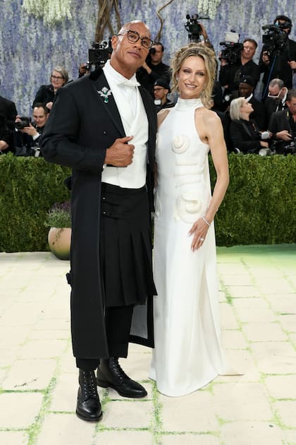 Dwayne Johnson junto a su esposa Lauren Hashian. El actor se animó a un traje con falda tableada mientras su mujer llevó un vestido blanco con detalles de pedrería