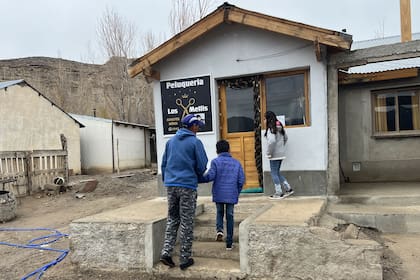 Dylan y Keyla vuelven caminando a su casa junto a su papá después de participar de apoyo escolar que brinda Cáritas en la parroquia.