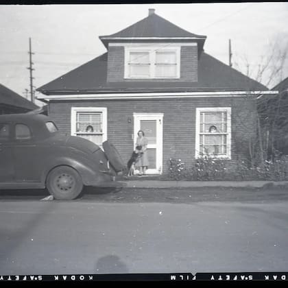 Edith Macefield frente a su casa, con el perro de un vecino y un Ford Coupé de finales de los años 30