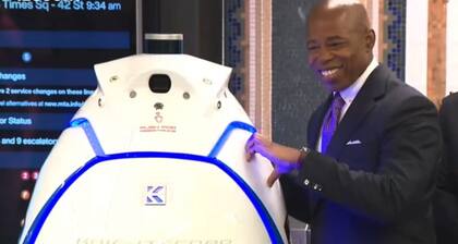 El alcalde de Nueva York, Eirc Adams, intenta hacer un corazón con el robot K5