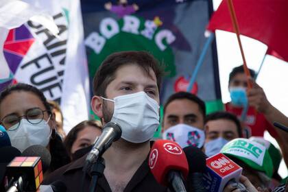 El candidato presidencial chileno por el partido Apruebo Dignidad, Gabriel Boric, rodeado por la prensa durante un mitin el último día de campaña, en Santiago, el 18 de noviembre de 2021