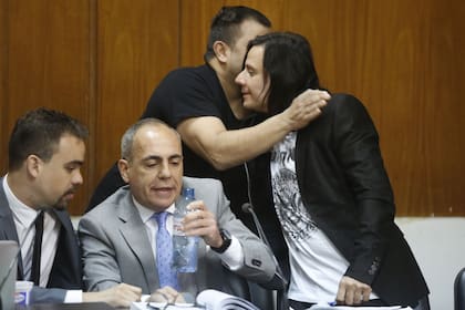 Aldana saluda a uno de sus amigos que fue a darle su apoyo en la audiencia