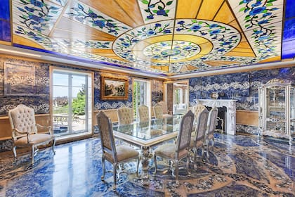 El comedor está rodeado de una decoración maximalista, con el elemento clave de la mansión en el techo.