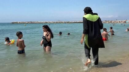 En la Riviera Francesa, una mujer se mete al mar vestida con burkini