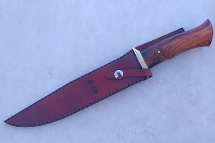 El cuchillo conmemorativo de los 40 años de la guerra de Malvinas en su vaina, tal como se lo llevará el que oferte un monto más alto en la subasta del viernes