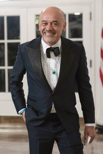 El diseñador Christian Louboutin, de impecable smoking, al que le sumó un collar estilo rosario.