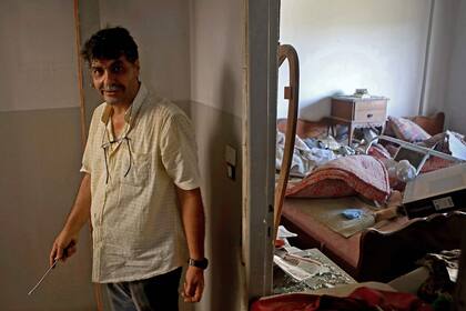 Un hombre trata de reparar algunas instalaciones de su casa en el barrio Mar Mikhael de Beirut