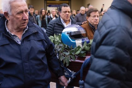 El emotivo momento en que retiraban el féretro de la parroquia Cristo Salvador, alrededor de las 18, entre el aplauso cerrado de los vecinos y la angustia de la familia. El detalle fue su casco azul y blanco, que Traverso pidió que estuviera presente en la ceremonia.