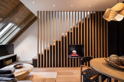 El espacio de estar de la Suite Messi, con área de descanso, iluminación natural y acabados en madera