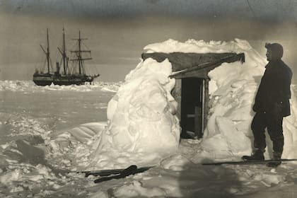 El físico Reginald James (1891 - 1964) en la puerta de su observatorio durante la Expedición Transantártica Imperial, 1914-17, dirigida por Ernest Shackleton. El 'Endurance' está en el fondo. (Foto de Frank Hurley/Scott Polar Research Institute, Universidad de Cambridge/Getty Images)