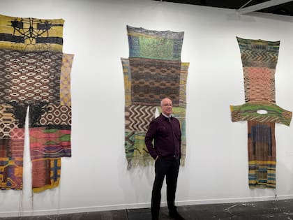 El galerista Mauro Herlitzka y las piezas textiles del colectivo Tsufwelej exhibidas en ARCO
