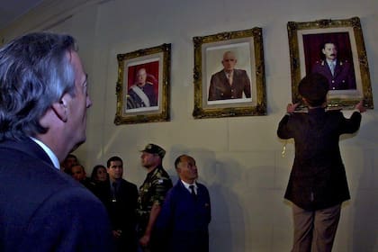 El general Bendini baja el cuadro de Videla en el Colegio Militar ante la mirada de Kirchner
