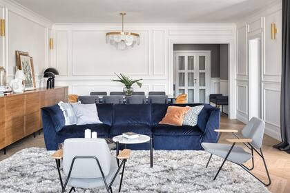 El gran sofá de Natuzzi tapizado en terciopelo royal blue es el protagonista absoluto del ambiente.