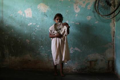 Judimar, la hermana de José Alfredo y Anderson Torres, quienes murieron después de ser baleados por agentes de la FAES, sostiene una camisa de José Alfredo