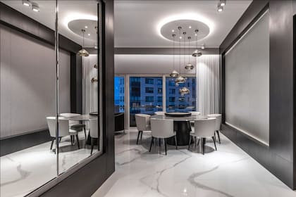 El hall de entrada con terminaciones en mármol y espejos, los cuales generan una sensación de mayor amplitud