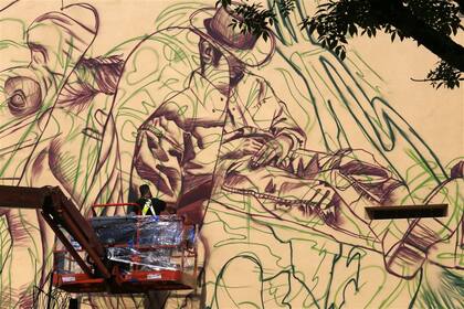 El holandés Telmo Pieper en acción, en Caffarena al 110, donde realiza un mural con impronta tanguera