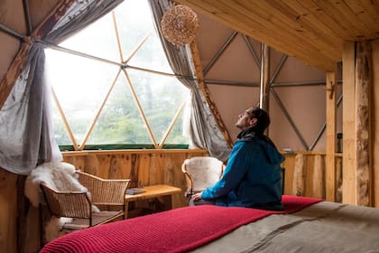 El interior de uno de los domos, con cama, baño, alfombras, sillones mullidos y vista privilegiada.
